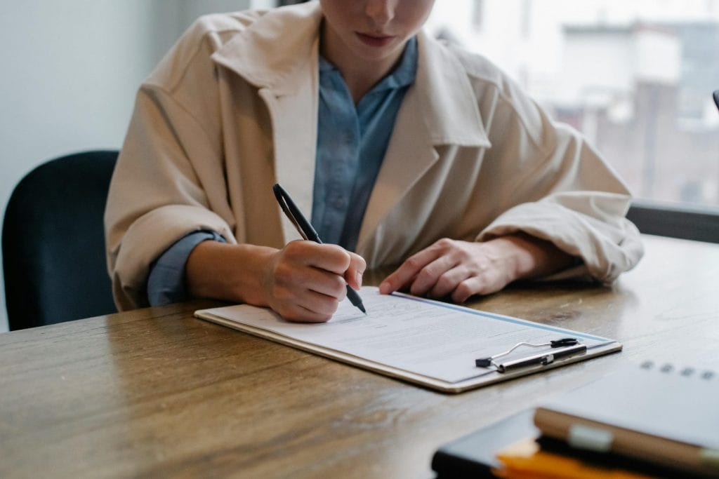 A woman writing depicting getting hired as a creative 