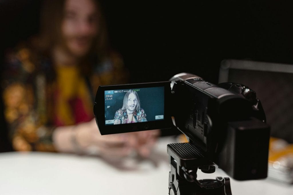 A man recording himself on camera depicting how to get hired as a creative.